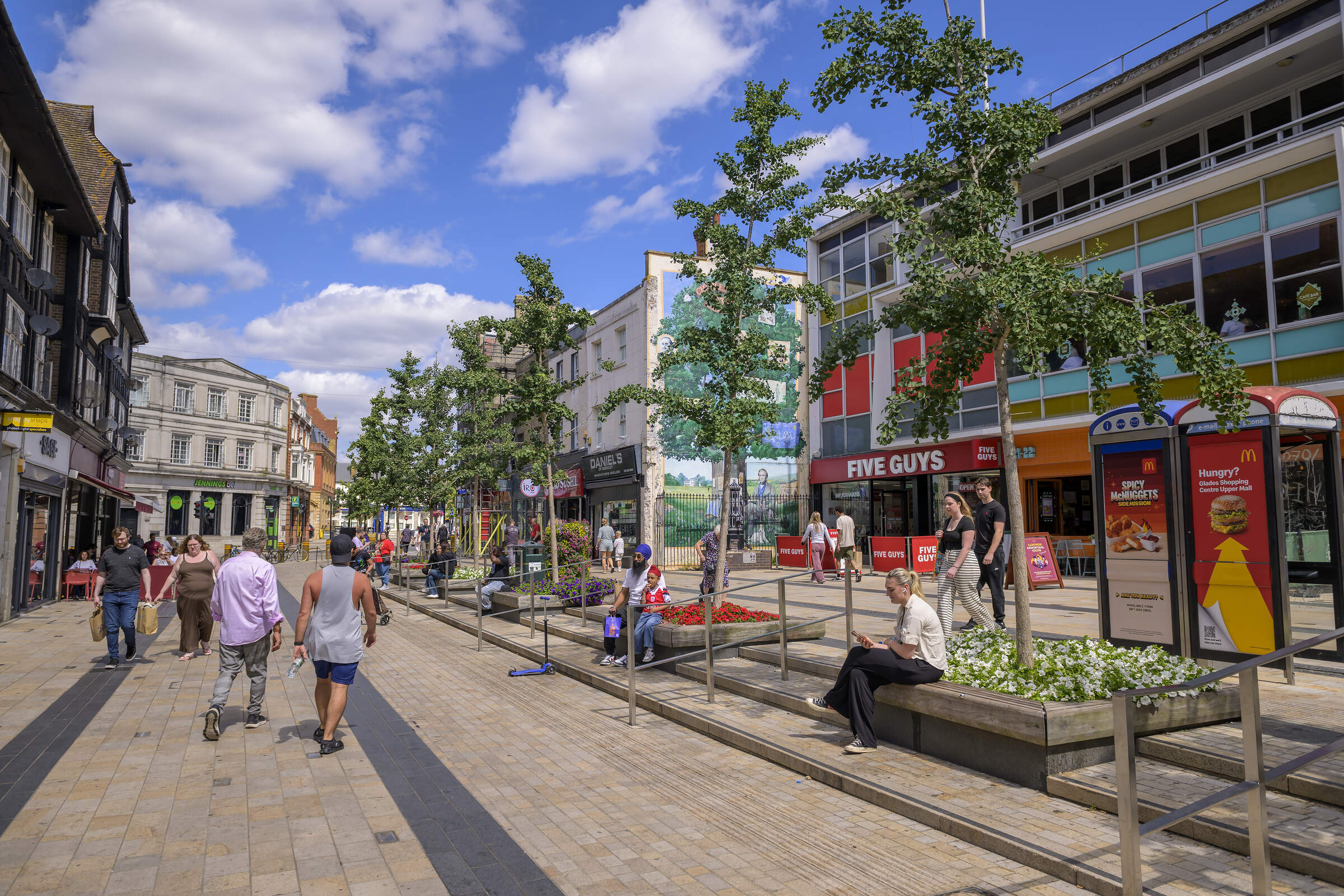 A summer's day on Bromley High Street – shoppers among the trees and planters